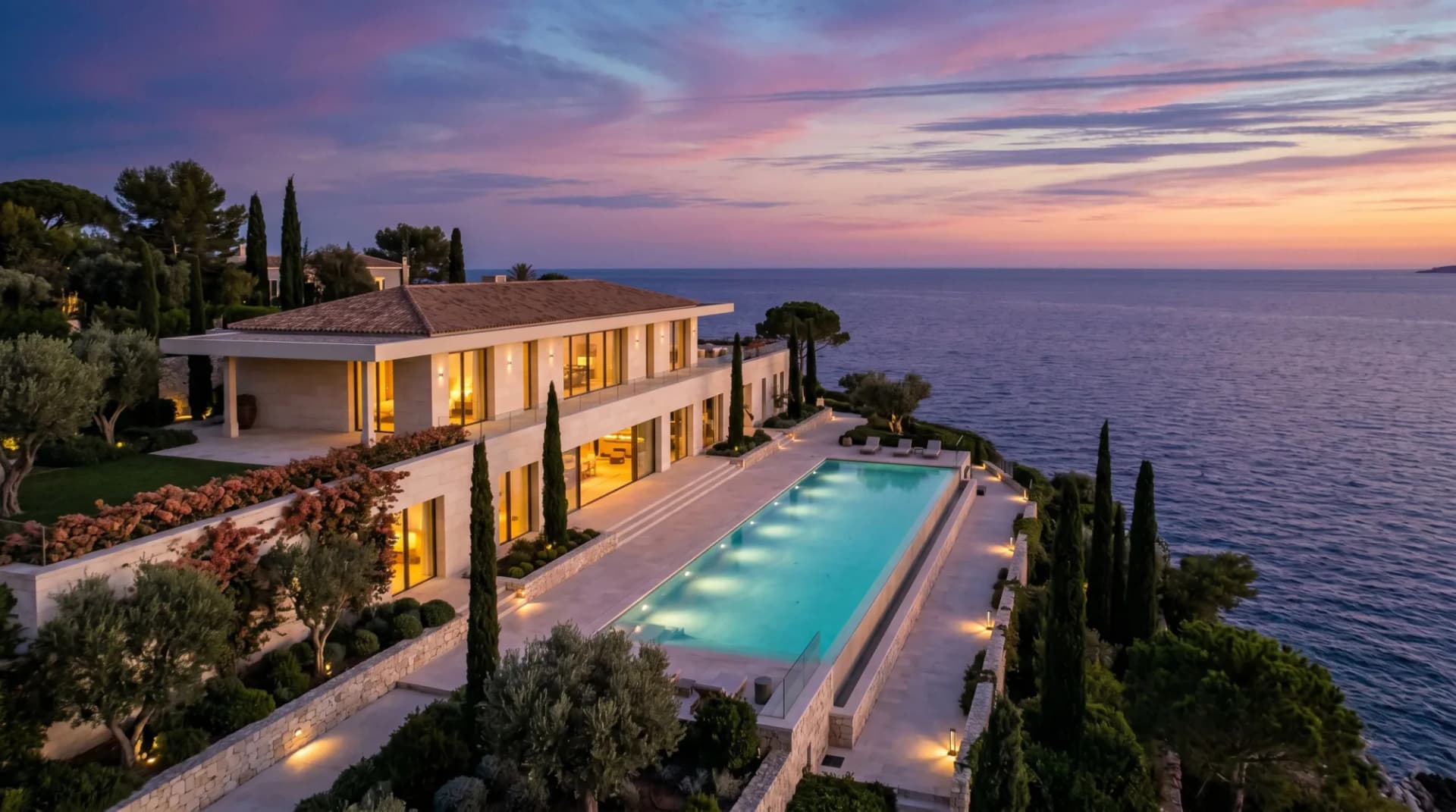 Ultra-luxury coastal compound at twilight with infinity pool dissolving into the sea — the kind of viral mansion this guide unpacks ten of.