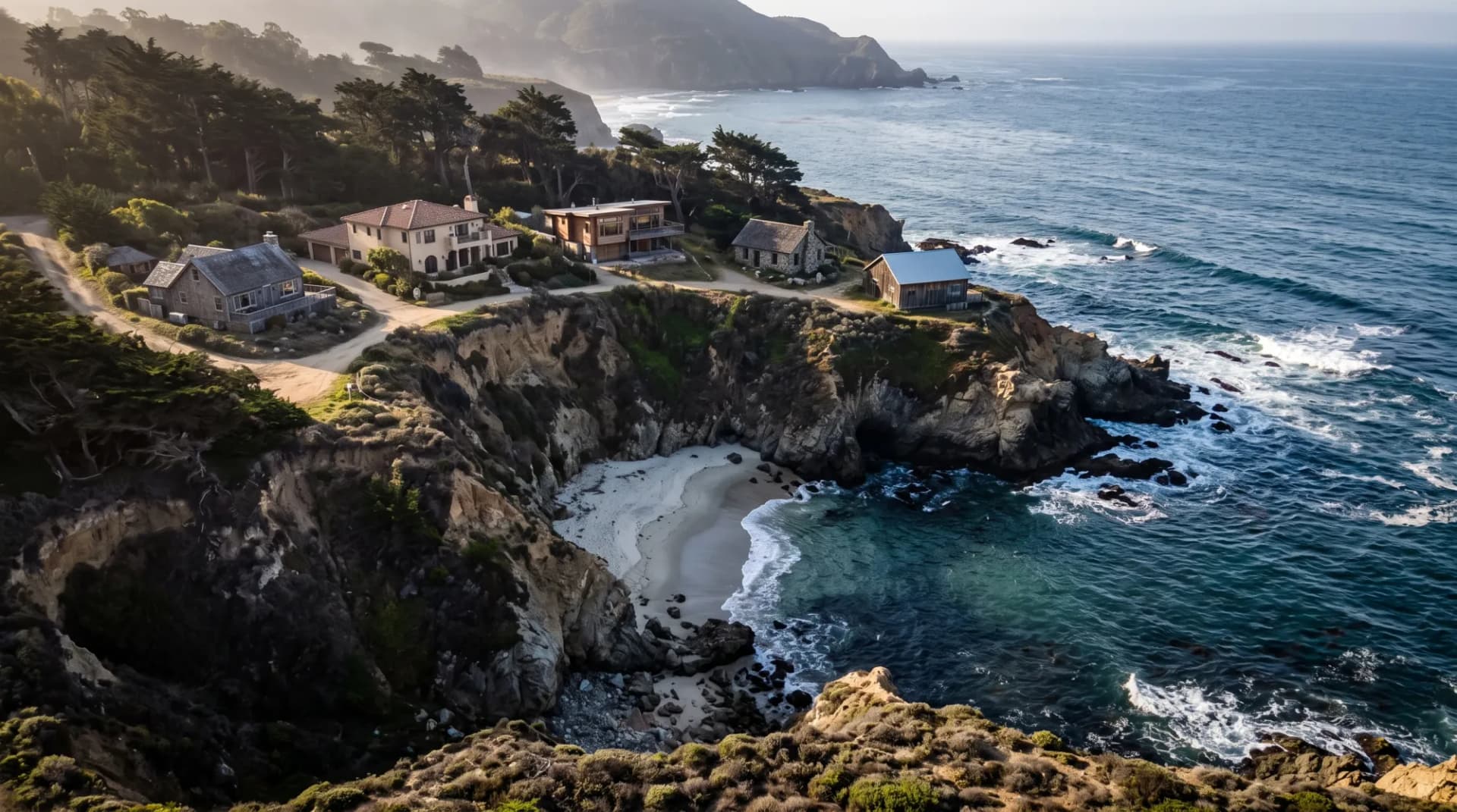 Aerial view of a small rocky cove with only a handful of houses on the bluff above it, illustrating the limited supply of prime coastal shoreline.